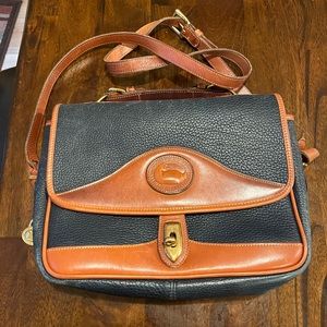 Vintage navy blue leather Dooney & Bourke shoulder purse/bag with duck emblem.